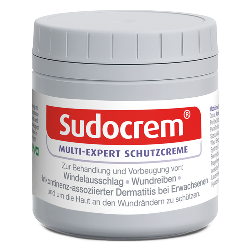 Runde, graue Dose mit Sudocrem Schutzcreme und rotem Schriftzug, behandelt Hautprobleme.